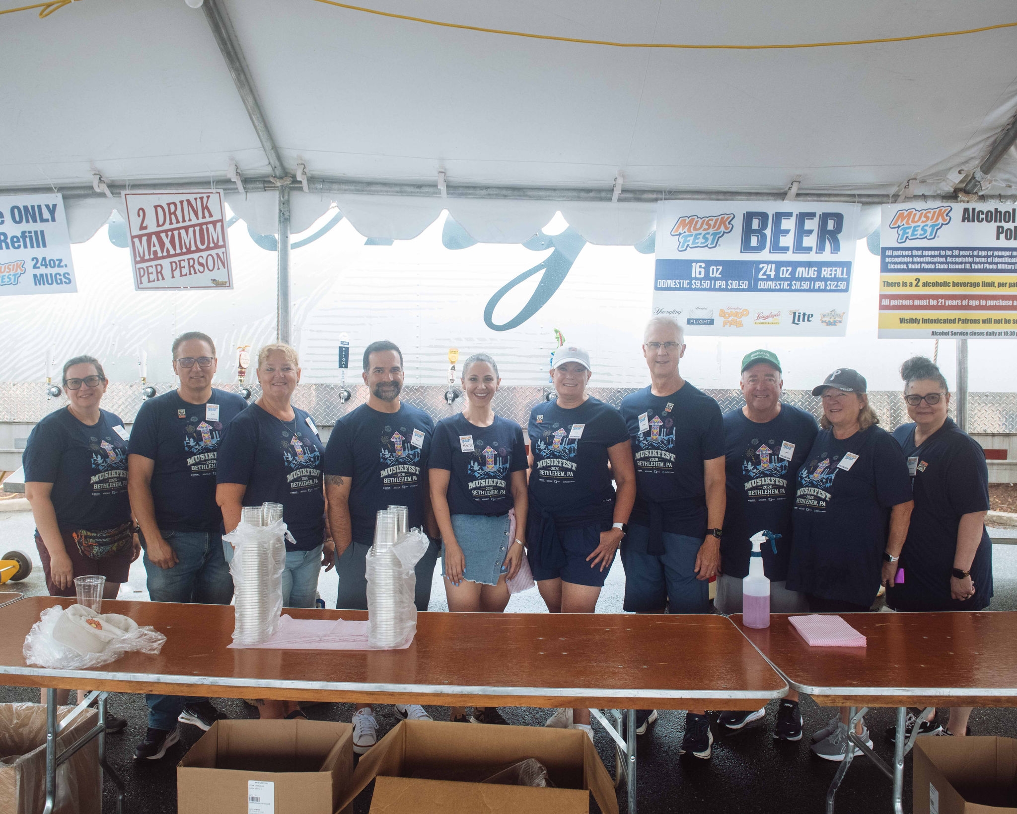 B. Braun employees volunteering together during B. Braun Volunteer Night at Musikfest 2025, staffing a food and beverage stand.