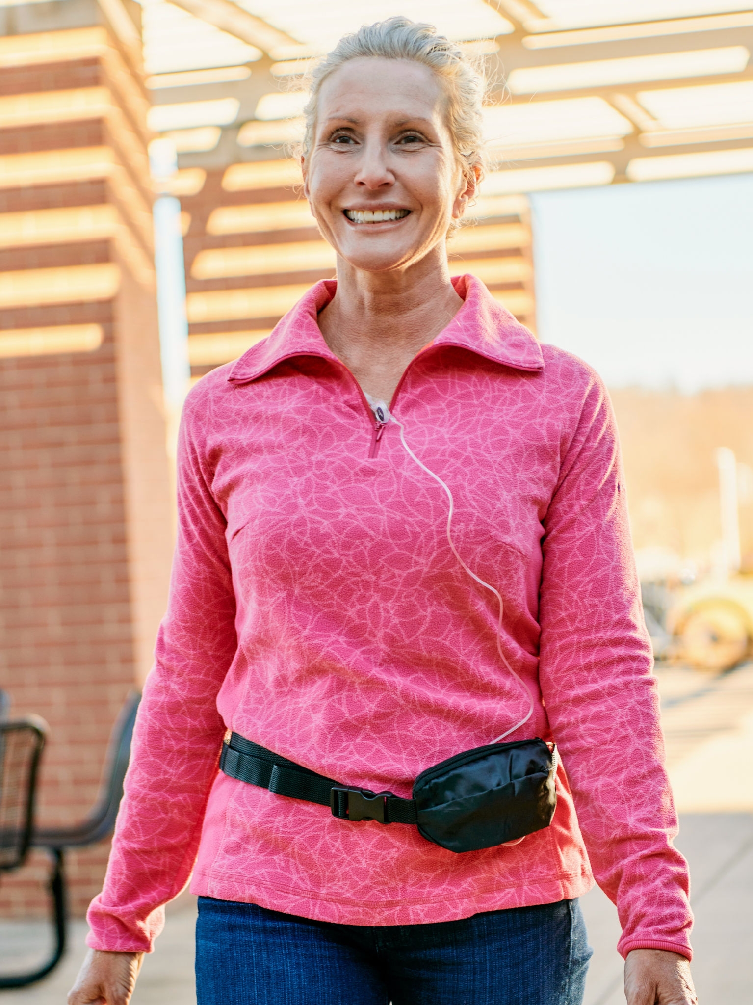 Woman carrying a B. Braun Easypump® Elastomeric Pump System during infusion therapy.