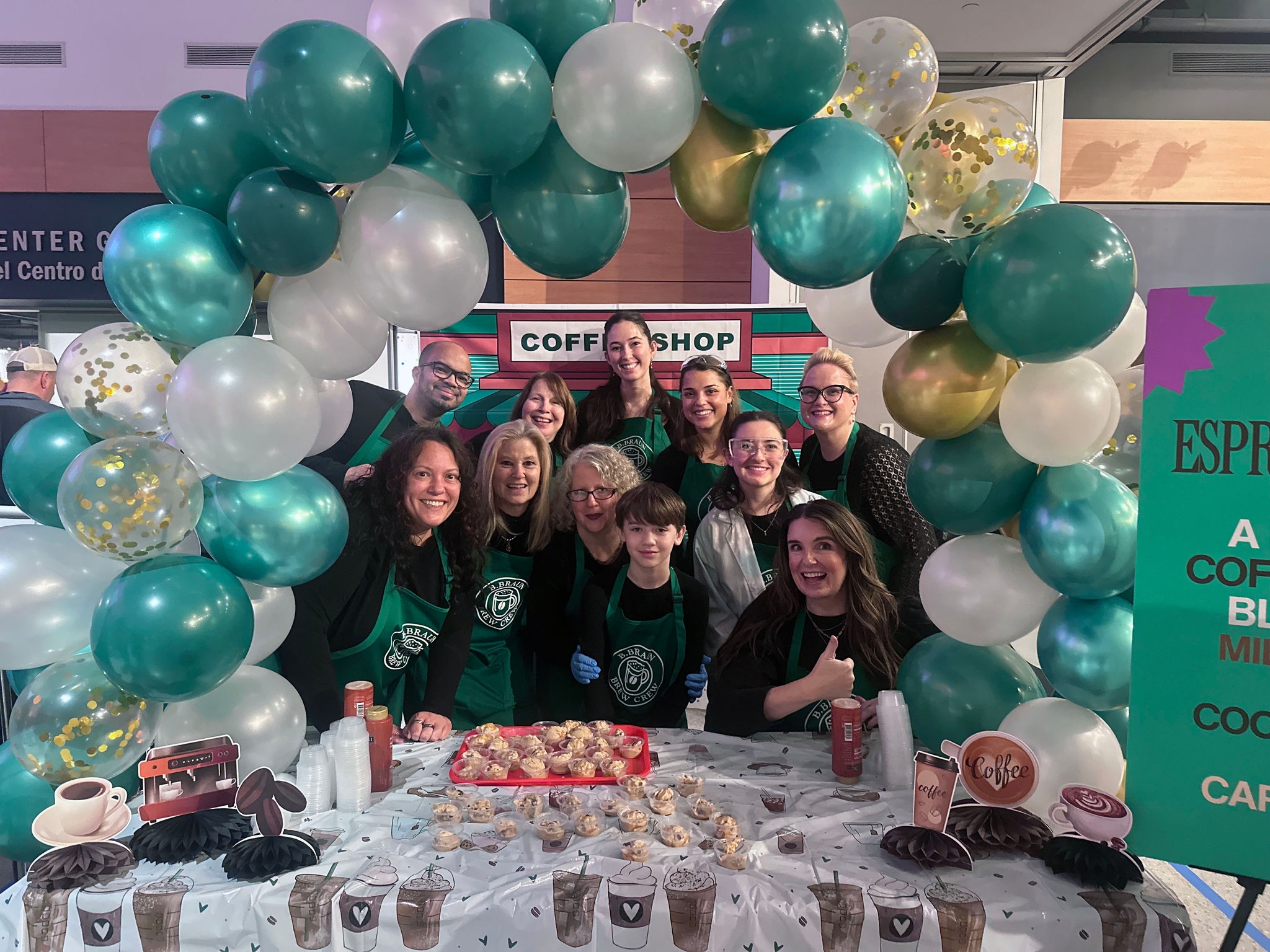 B. Braun employees at the Da Vinci Science Center Ice Cream Wars event, gathered around their decorated booth with dessert samples and event displays.