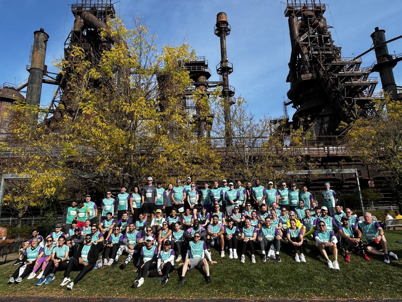 B. Braun employees participating in the Half Marathon Relay Corporate Challenge at the Bethlehem Running Festival, gathered at SteelStacks for a team photo.