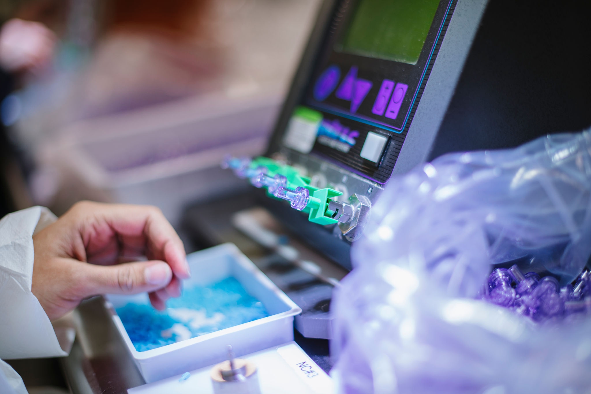 A persons hand using a digital device with a touchscreen interface and colorful graphics.