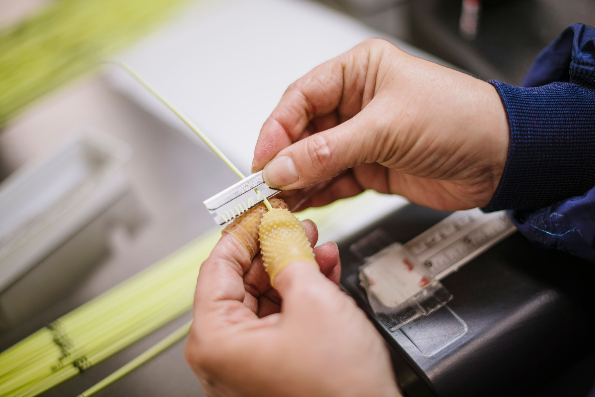 Close-up of two hands assembling a product. 
