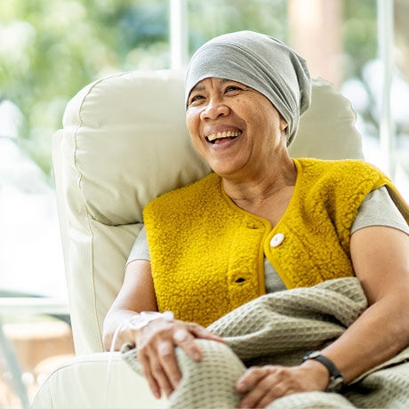 A patient sitting in a recliner undergoing chemotherapy.