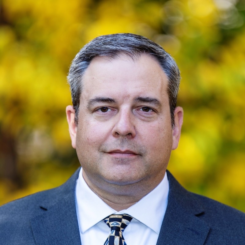 Associate Director of Sustainability & Packaging, Christian Hutter, smiling outside.