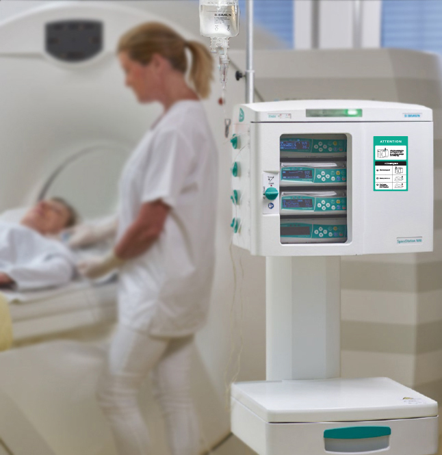 Close up of the Spacestation MRI on the right side of the image, with a provider preparing a patient for an MRI out of focus in the background on the left. 