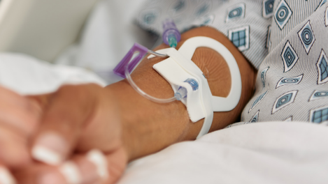  A close-up of a Clik-FIX Securement Device on a patient's forearm. 